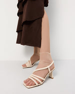 Sandały damskie Estro w kolorze jasnobeżowym z cienkich pasków na obcasie – prezentacja na nodze.