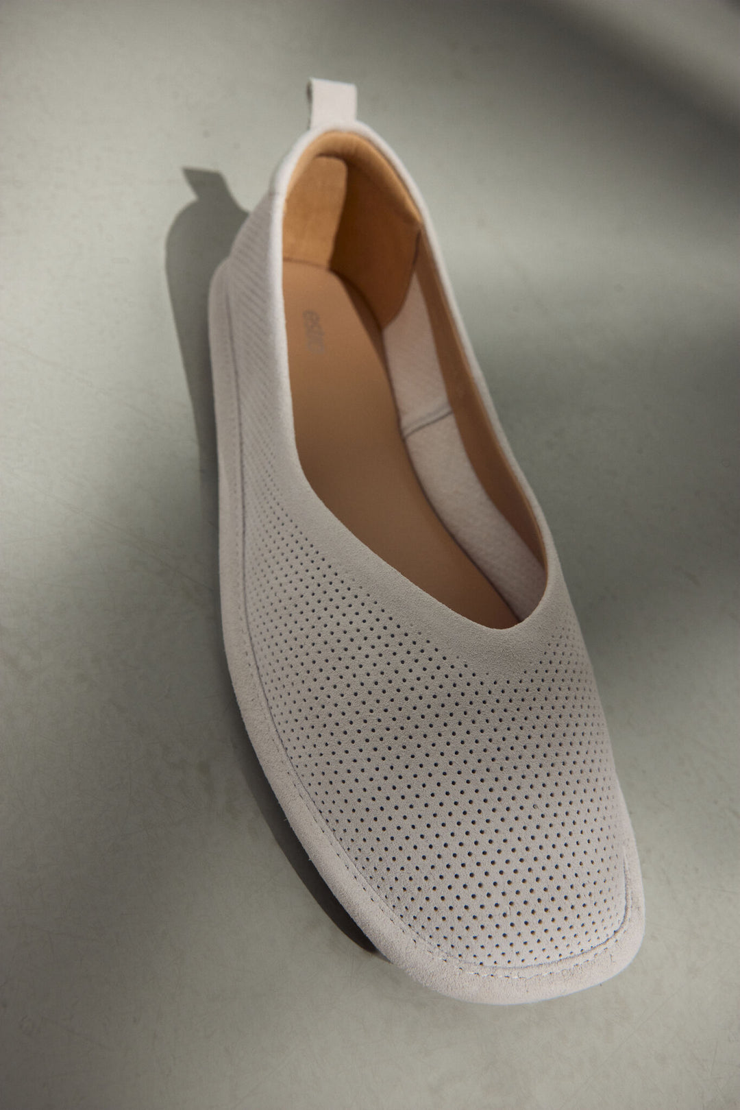 Miękkie, białe baleriny damskie z naturalnego weluru z perforacją marki Estro.
