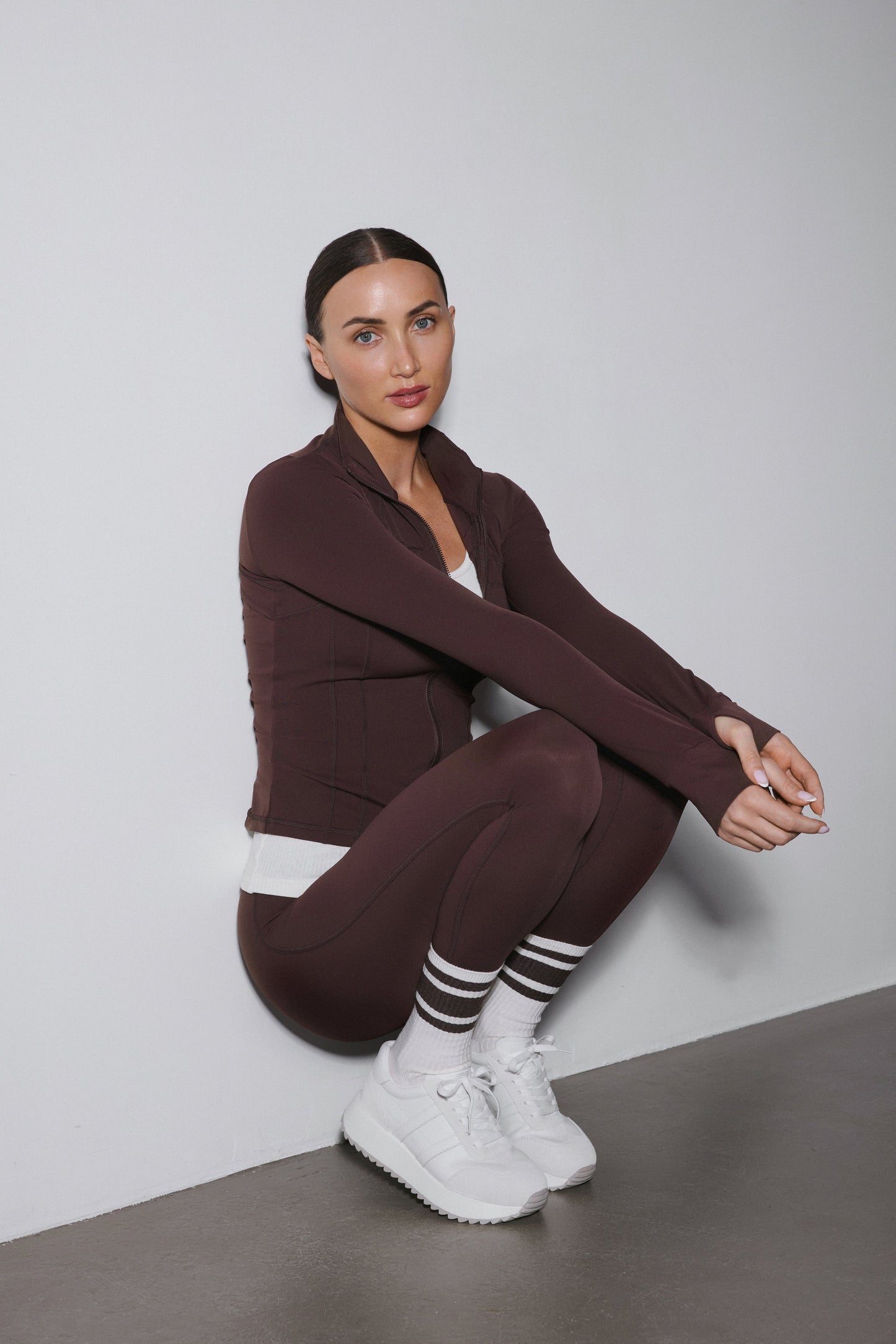 Ciemnobrązowy komplet dresowy Estro składający się z bluzy ze stójką i spodni slim fit.