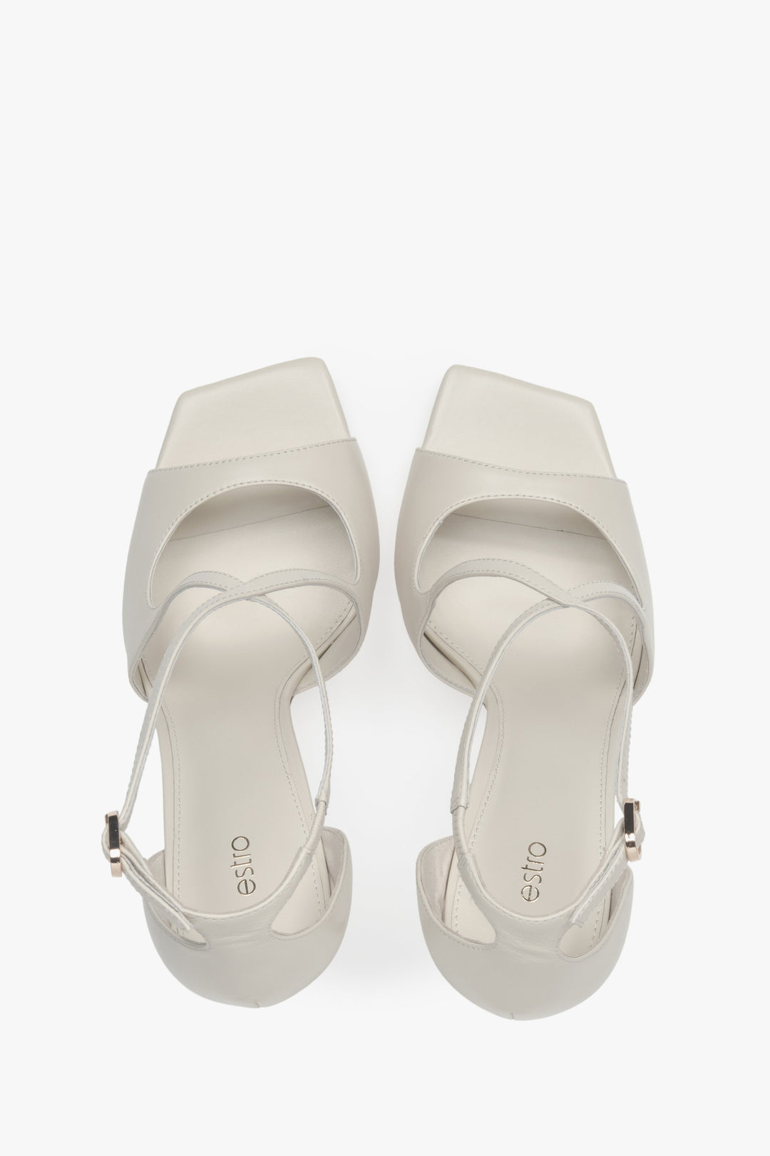 Sandałki damskie na szpilce Estro, jasnobeżowe, z ozdobnym zapięciem.